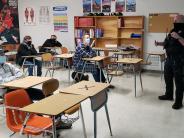 Police officer standing in front of a classroom of students